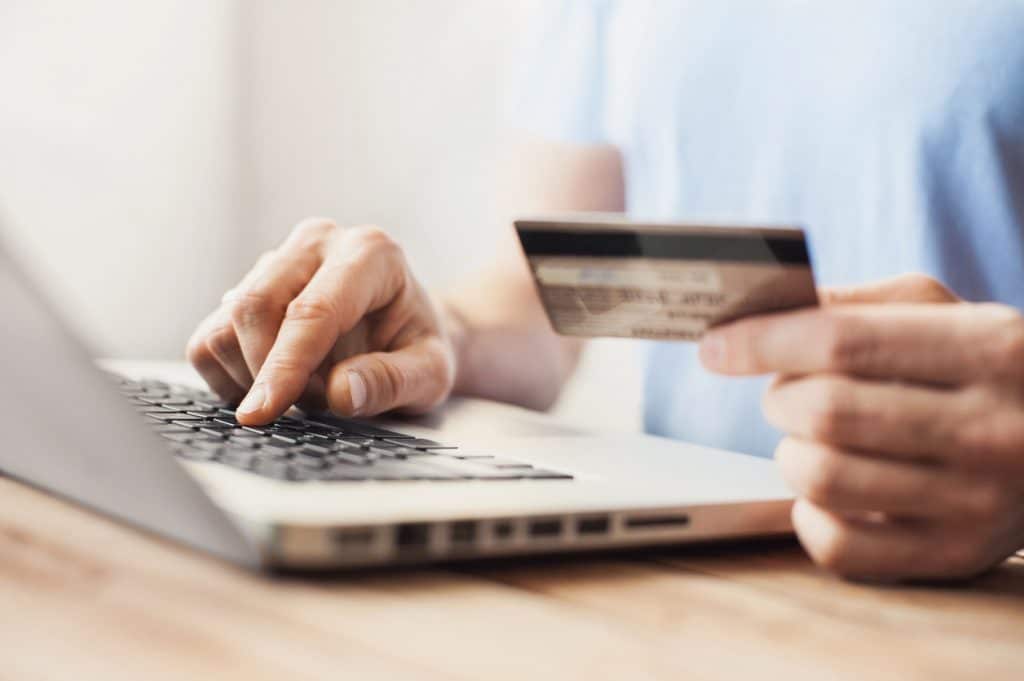 Man is shopping online with laptop