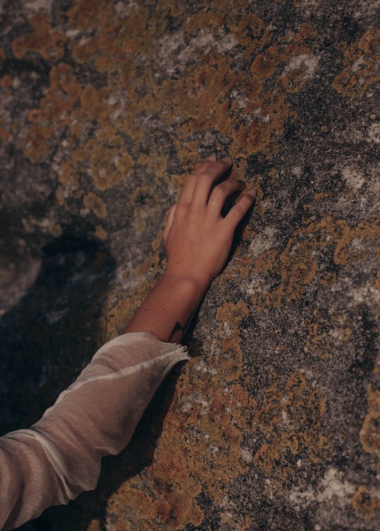 Free Person Touching Rock Stock Photo