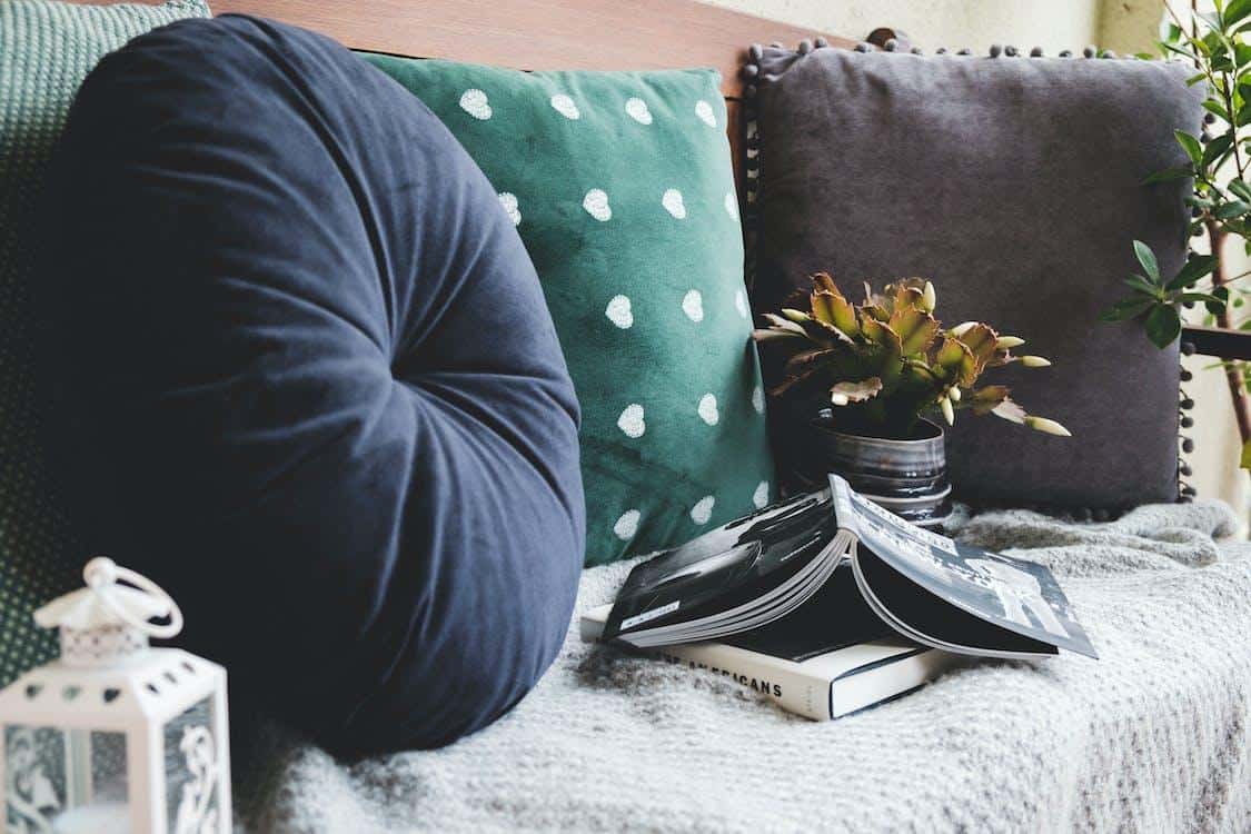 Free Throw Pillows Beside Books Stock Photo